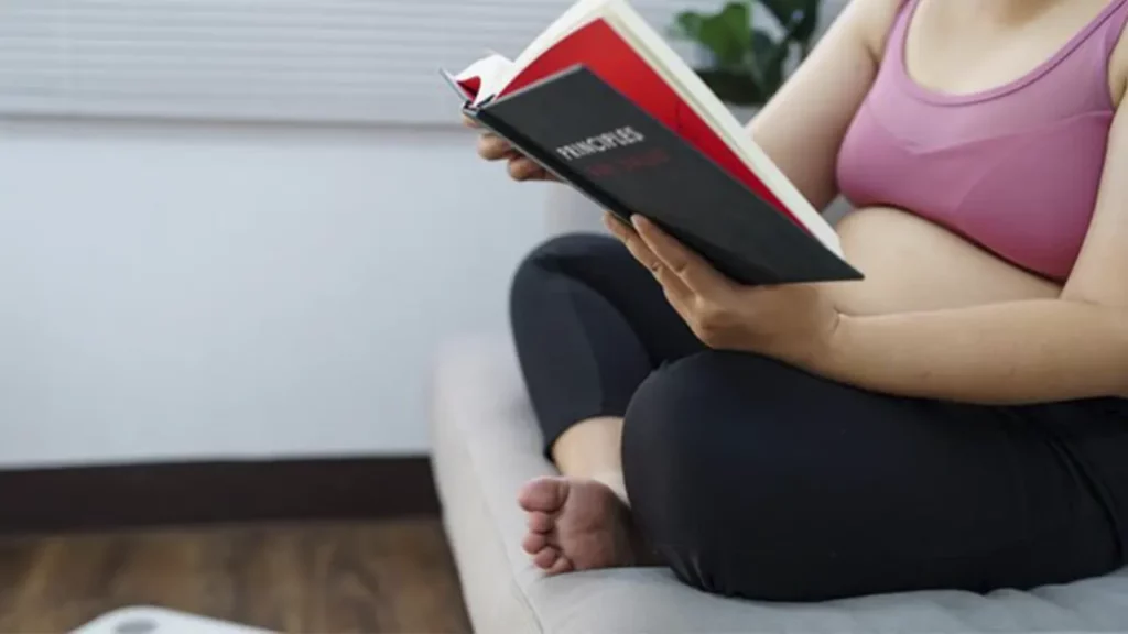 A woman reading a book and gaining information about weight loss surgeries.