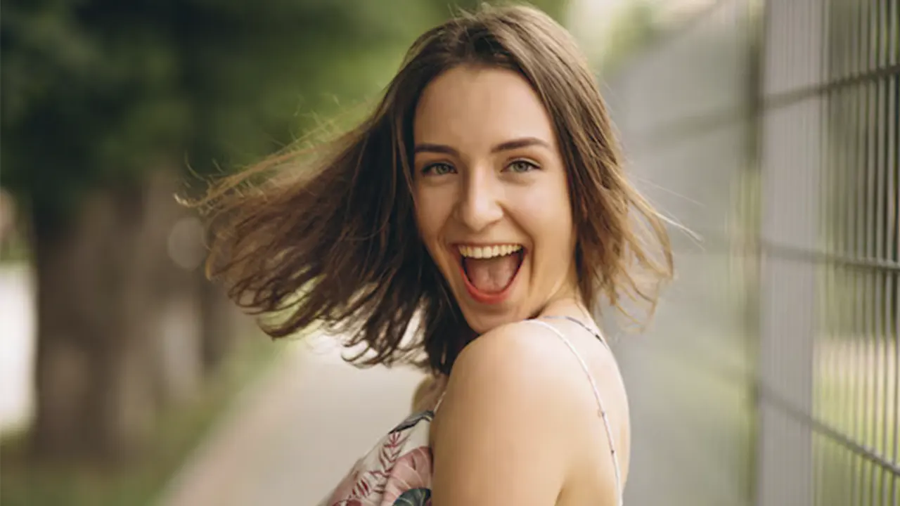A woman who has lost weight and is laughing after enjoying the benefits of weight loss surgery