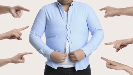 Fat man with hands pointing at him