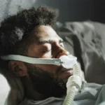 A man who sleeps with a device due to sleep apnea