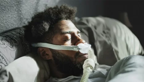 A man who sleeps with a device due to sleep apnea