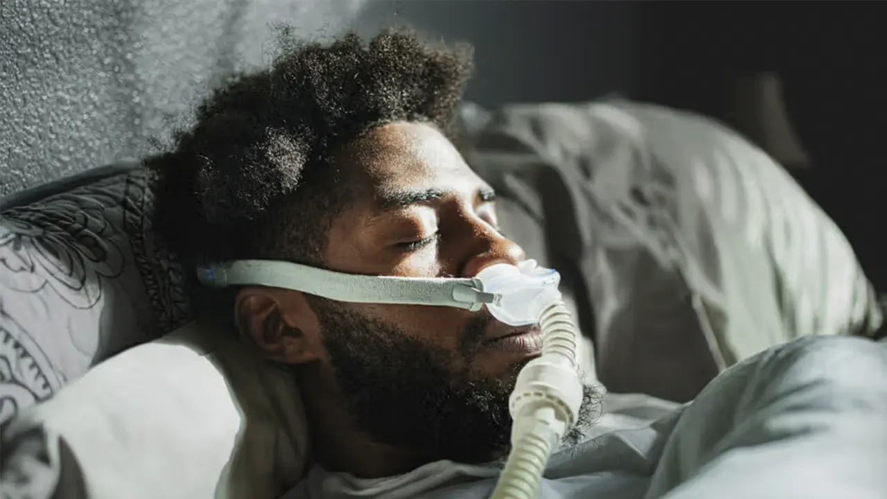 A man who sleeps with a device due to sleep apnea