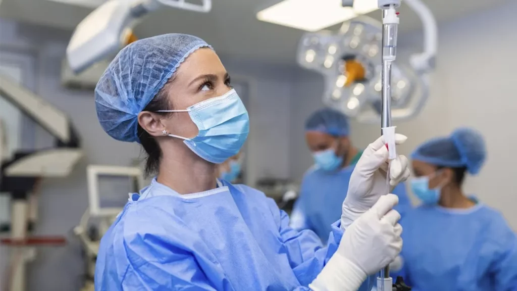 Anesthesiologist injecting medication into the serum fluid
